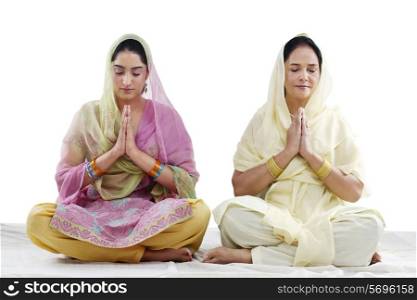 Mother and daughter praying