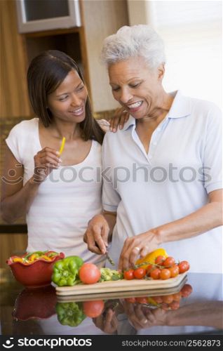 Mother And Daughter Preparing A meal,mealtime Together