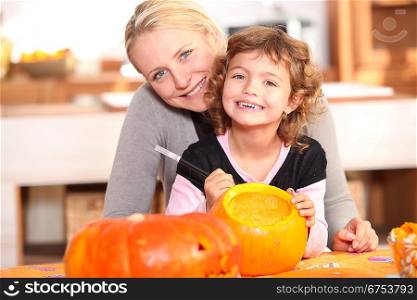 Mother and daughter pumpkin carving