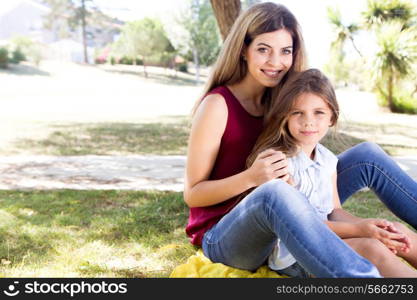 Mother and daughter relaxing in the city park