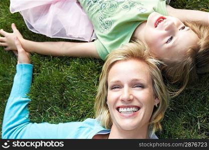 Mother and Daughter Relaxing in the Grass