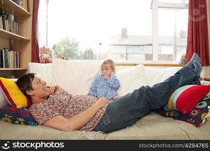 Mother and daughter relaxing on couch