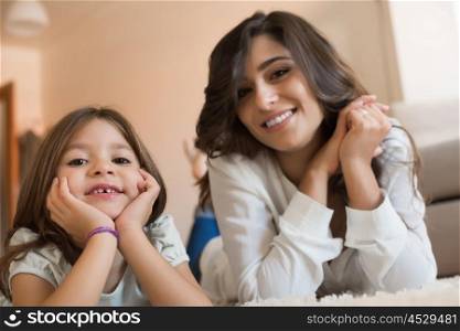 Mother and daughter relaxing together at home