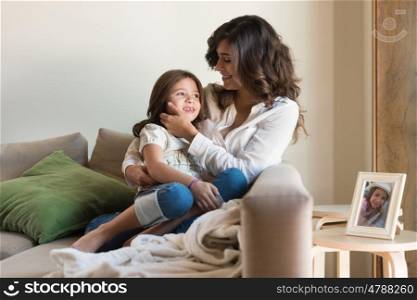 Mother and daughter relaxing together in the living room