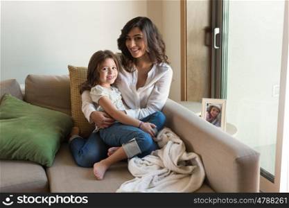 Mother and daughter relaxing together in the living room