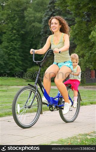 Mother and daughter ride on bicycle