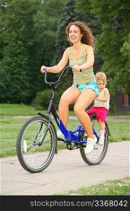 Mother and daughter ride on bicycle