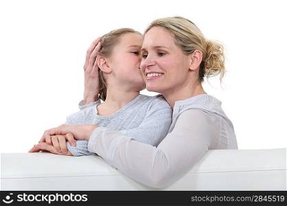 Mother and daughter sat on sofa