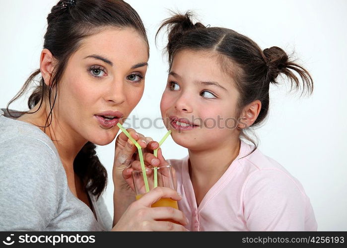 Mother and daughter sharing a drink