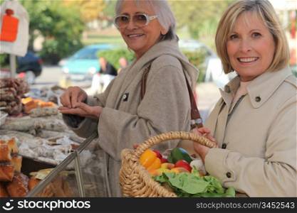 Mother and daughter shopping at the market together
