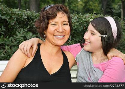 mother and daughter sit on the bench