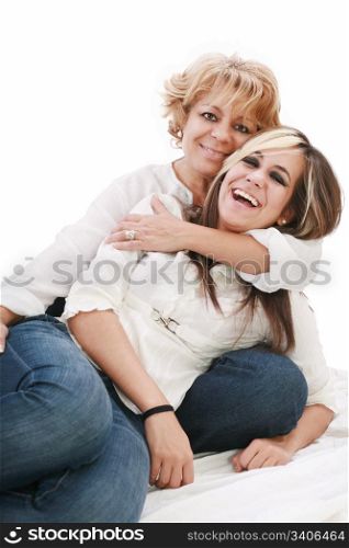 Mother and daughter sitting and laughing on the floor