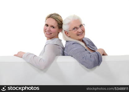 Mother and daughter sitting together