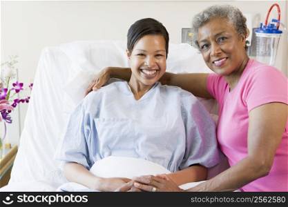 Mother And Daughter Smiling In Hospital