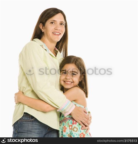 Mother and daughter standing holding eachother smiling.