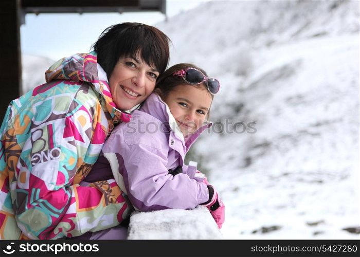 Mother and daughter stood by chalet