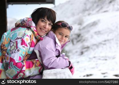 Mother and daughter stood by chalet