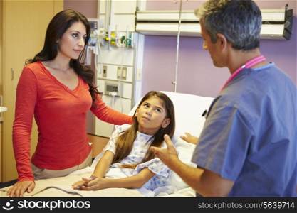 Mother And Daughter Talking To Consultant In Hospital Room