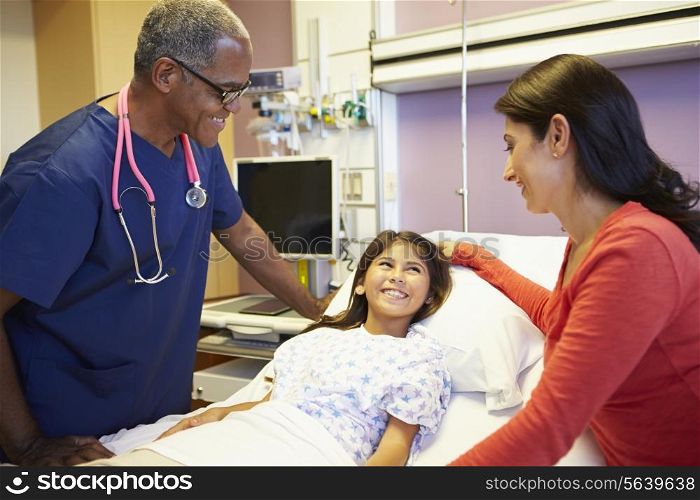 Mother And Daughter Talking To Male Nurse In Hospital Room