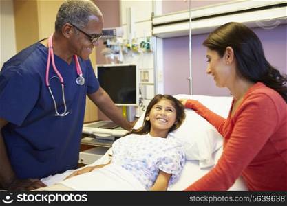 Mother And Daughter Talking To Male Nurse In Hospital Room