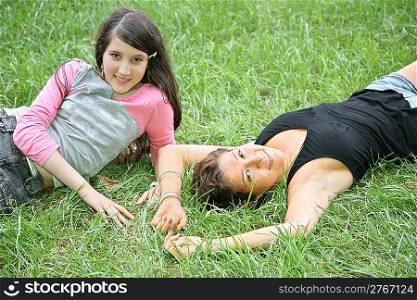 mother and daughter-teenager lie on the grass 2