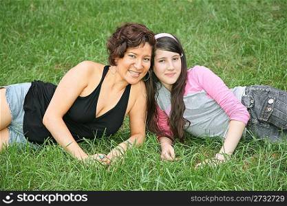 mother and daughter-teenager lie on the grass 3