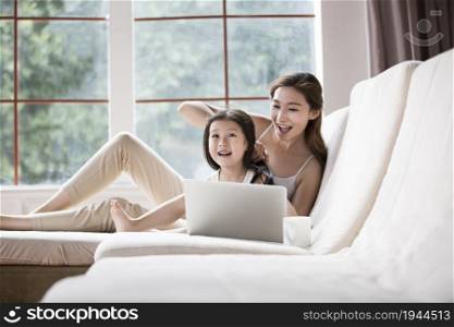 Mother and daughter using a laptop computer