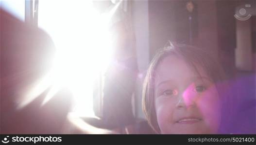 Mother And Daughter Using A Tablet at home with sun rays coming from window