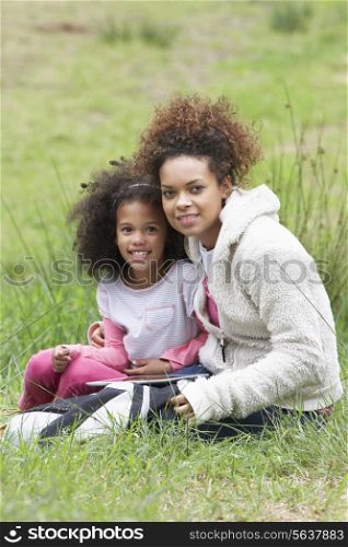 Mother And Daughter Using Digital Tablet Countryside