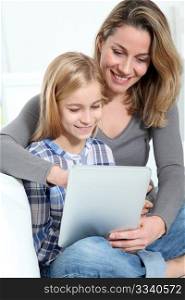 Mother and daughter using electronic tab