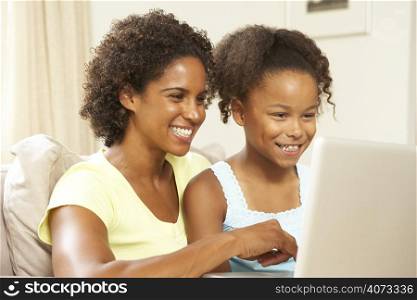 Mother And Daughter Using Laptop At Home