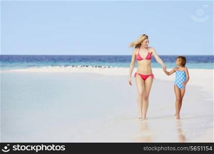 Mother And Daughter Walking On Beautiful Beach