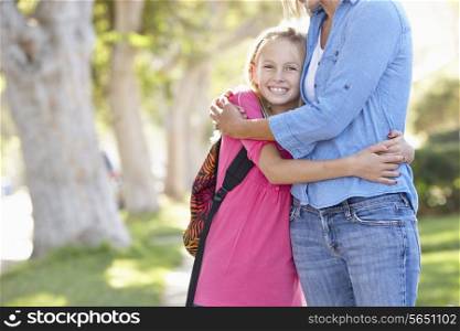 Mother And Daughter Walking To School On Suburban Street