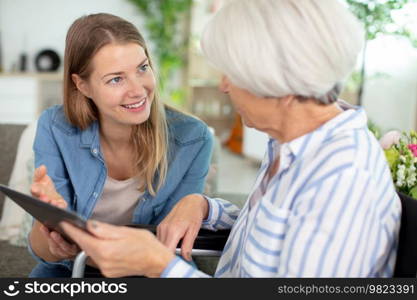 mother and daughter watch tablet