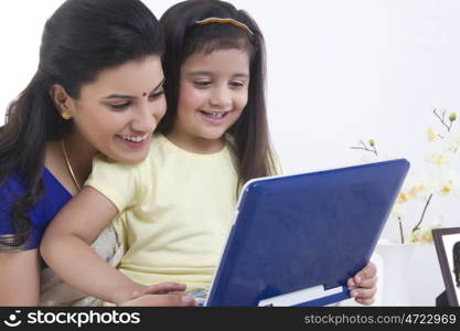 Mother and daughter with a computer