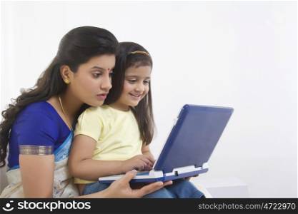 Mother and daughter with a computer