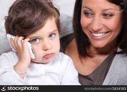 Mother and daughter with a mobile telephone