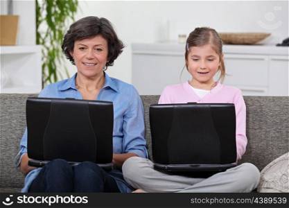 Mother and daughter with computers