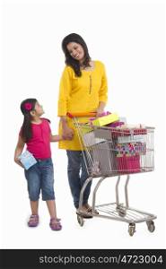 Mother and daughter with gifts in shopping cart
