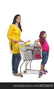 Mother and daughter with gifts in shopping cart
