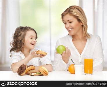 mother and daughter with healthy and unhealthy food