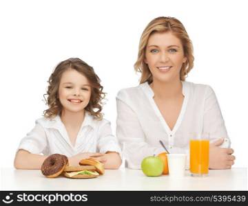 mother and daughter with healthy and unhealthy food