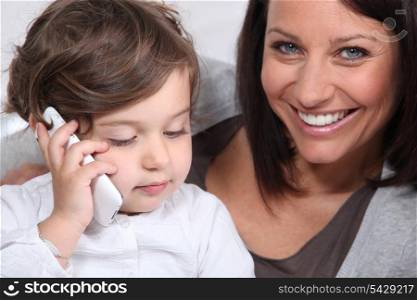 Mother and daughter with mobile telephone