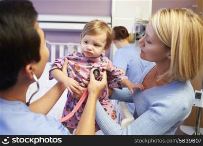 Mother And Daughter With Staff In Pediatric Ward Of Hospital