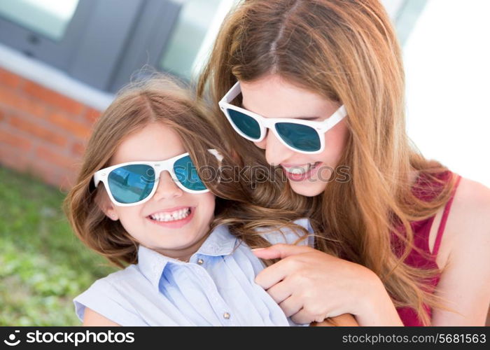 Mother and daughter with sunglasses and having fun