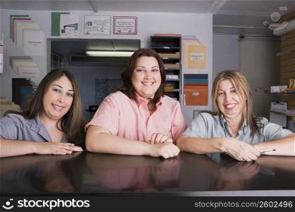 Mother and daughters at work in copy center