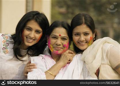 Mother and daughters celebrating Holi