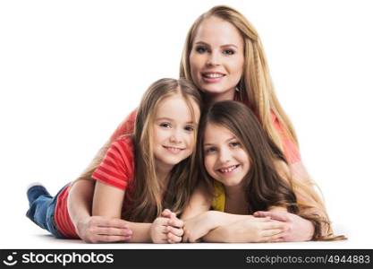 Mother and daughters lying on the floor. Mother and daughters lying on the floor isolated on white background