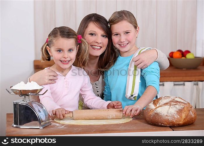 Mother and daughters making bread