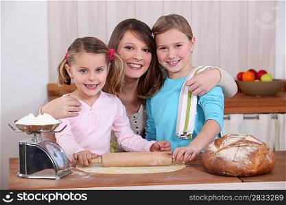 Mother and daughters making bread